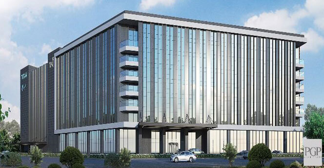 Modern glass façade commercial office building with landscaped surroundings at PGP Tech Park, showcasing premium IT infrastructure in Chennai.