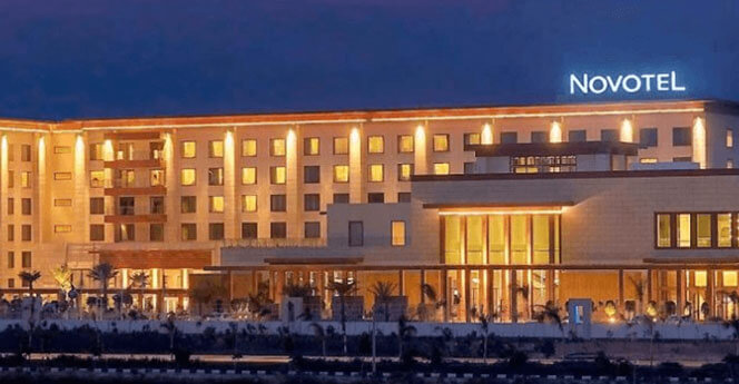 Novotel hotel building illuminated at night with clear signage and modern architecture.